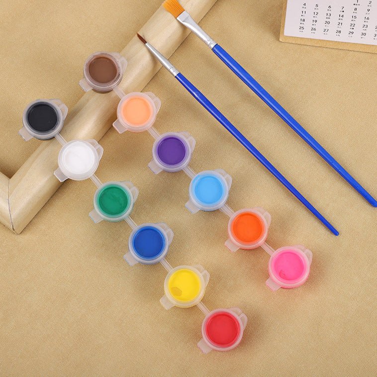 A colorful assortment of paint pots and brushes for a wooden bird craft kit