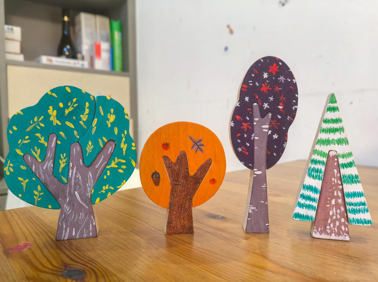 Real customer colorful painted wooden trees in a seasonal display