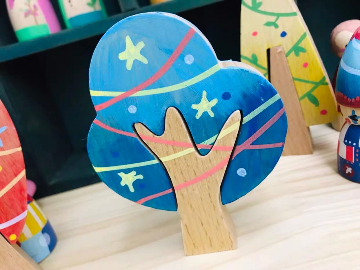 Blue customer painted wooden tree with star patterns
