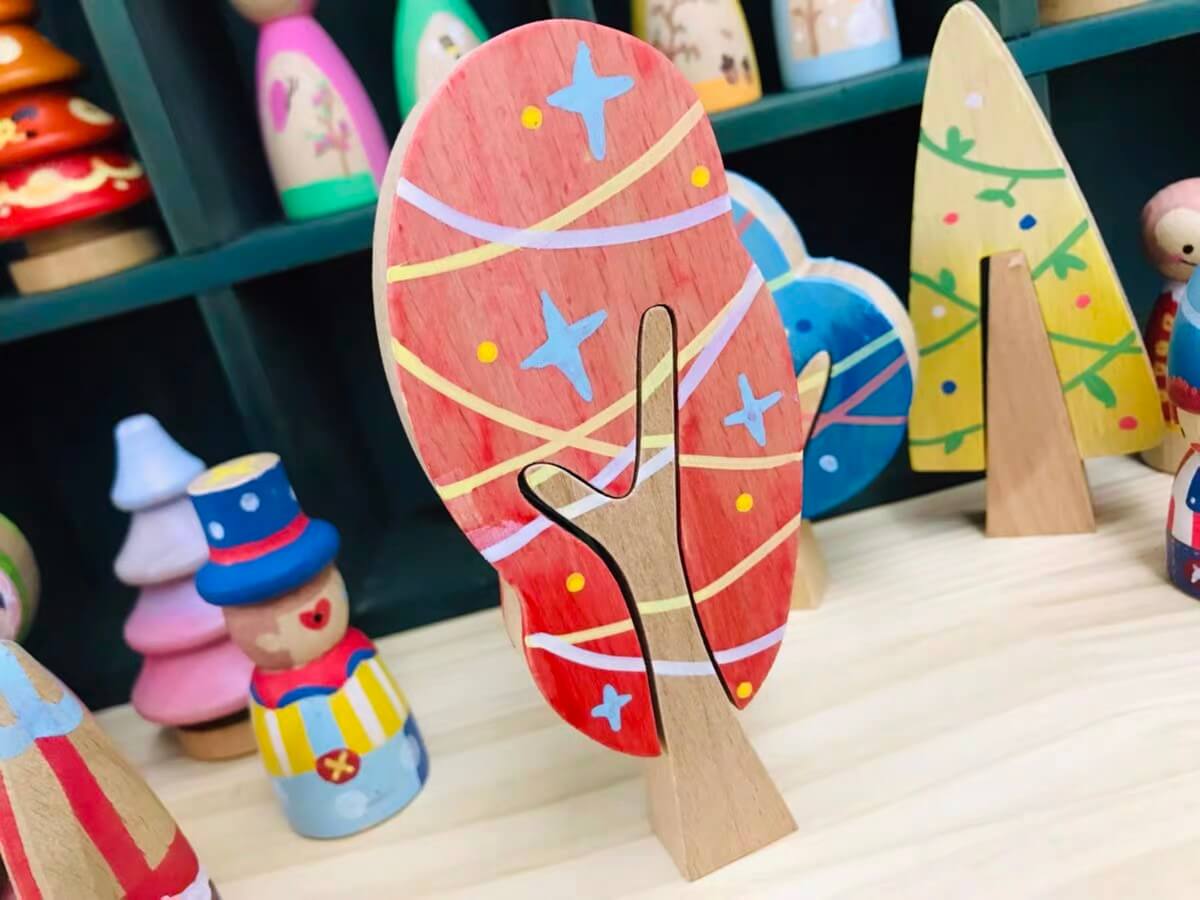Coral customer painted wooden tree with star patterns