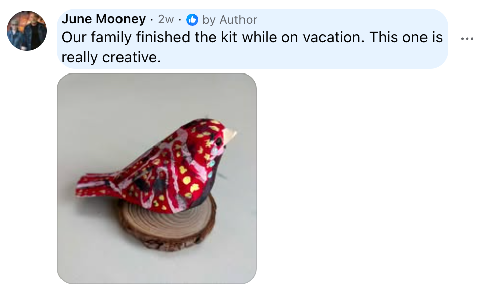 Customer review featuring a red spotted hand-painted wooden bird on a wood slice