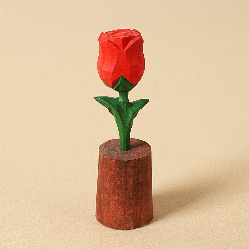 A beautifully carved wooden red rose atop a wooden base.
