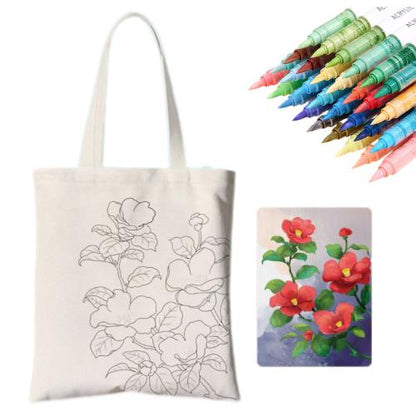 A DIY tote kit featuring a floral design, surrounded by colorful markers and a painted flower artwork.