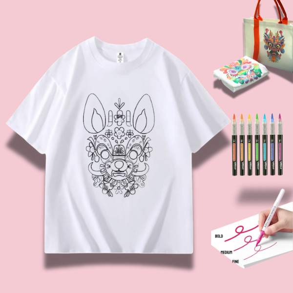 A white t-shirt featuring a detailed doodle of a proud dog surrounded by art supplies including markers and watercolor paints.