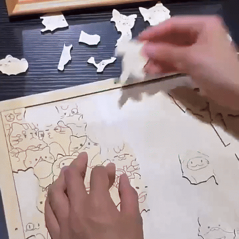 A person assembling a fun acrylic puzzle with various whimsical animal shapes.