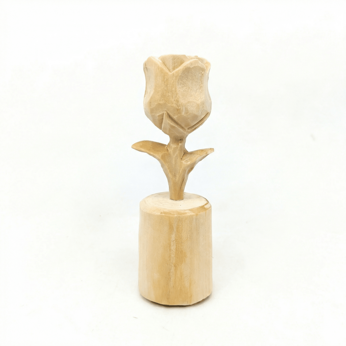 A handcrafted wooden rose flower decoration on a cylindrical base.
