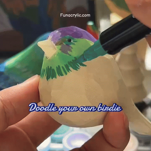 A person painting a colorful bird figurine with markers in a creative craft activity.