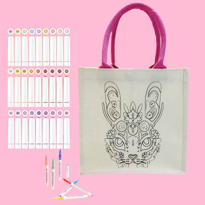 A canvas bag featuring a rabbit design alongside assorted coloring markers.