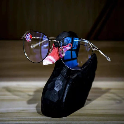 Elegant black swan wooden sculpture functioning as a practical eyeglass holder