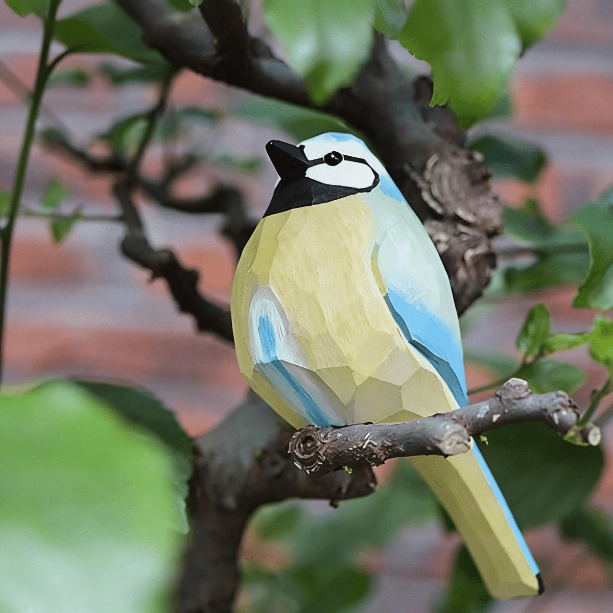 Vibrant hand-painted robin wooden figurine with striking blue and yellow plumage