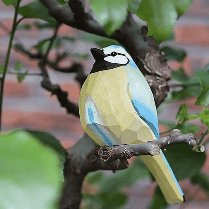Vibrant hand-painted robin wooden figurine with striking blue and yellow plumage
