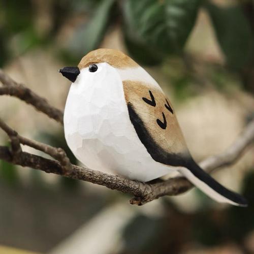 A hand-painted wooden bird sculpture featuring a brown-black body, white belly, and black beak, perfect as a charming home decor item