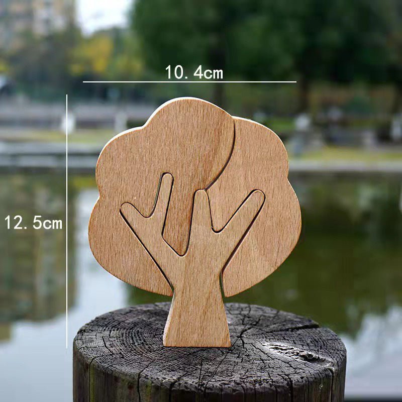A DIY hand-carved wooden tree, measuring 10.4cm wide and 12.5cm tall, displayed on a rustic log by a serene water body.