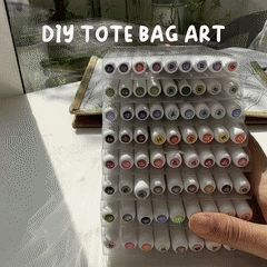 A display of colorful markers for customizing a tote bag in a DIY kit.