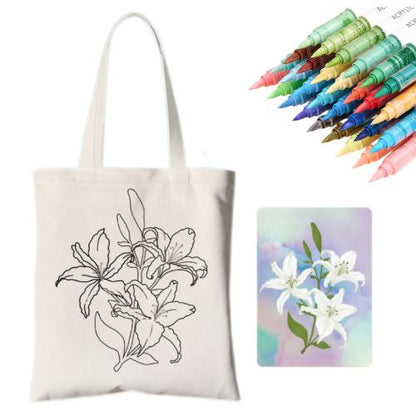 A DIY tote bag with floral design, accompanied by colorful markers and a framed flower artwork.