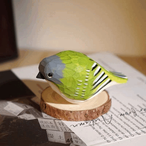 A dynamic GIF displaying diverse close-ups and lifestyle shots of a beautifully finished wooden bird, custom-painted with pink and blue acrylic paint. Shows the bird on a wooden block, with other craft animals, and as a hanging decoration. Part of a Funacrylic wooden animal painting kit.