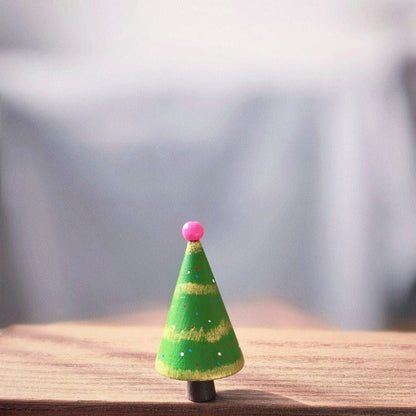 Green hand-painted wooden Christmas tree with gold stripes and a pink bead topper.
