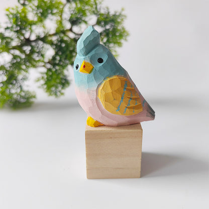 Blue and gold hand-carved wooden budgie figurine on a walnut base