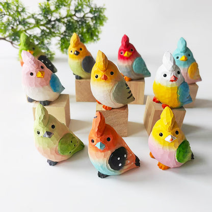 Hand-carved wooden budgie figurines arranged as a collectible display