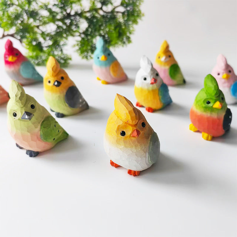 Collection of colorful hand-carved wooden budgie figurines