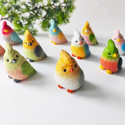 Collection of colorful hand-carved wooden budgie figurines