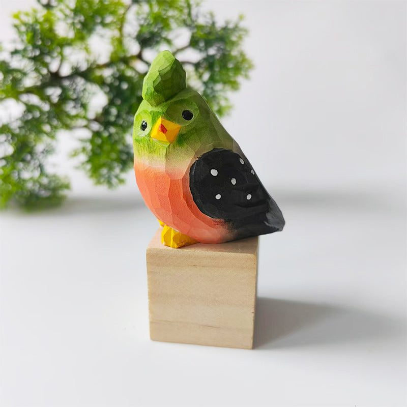 Green and coral hand-carved wooden budgie figurine on a walnut base