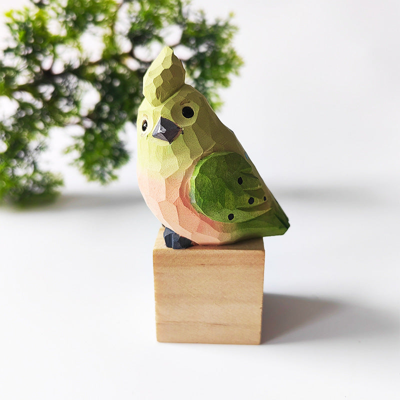 Olive green hand-carved wooden budgie figurine on a walnut base