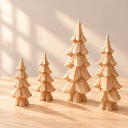 Four unfinished hand-carved wooden Christmas trees ready for painting