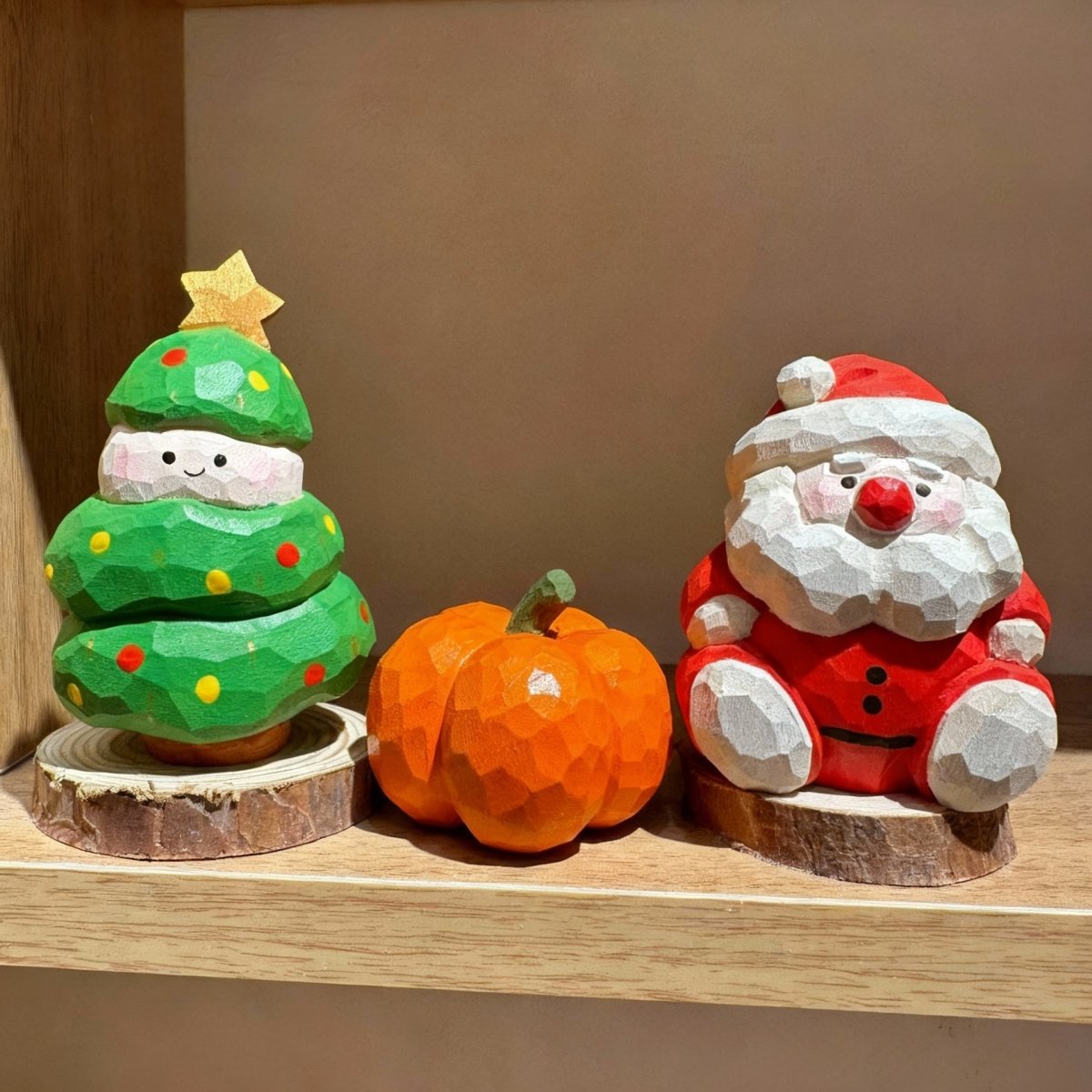 Set of hand-carved wooden Santa, Christmas tree, and pumpkin figures for holiday decor