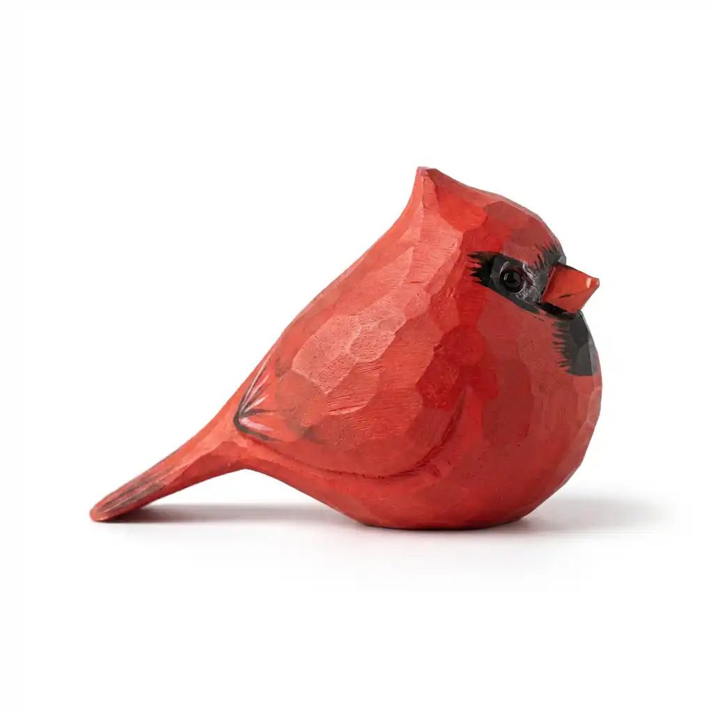 A beautifully carved red cardinal bird figurine with intricate details.