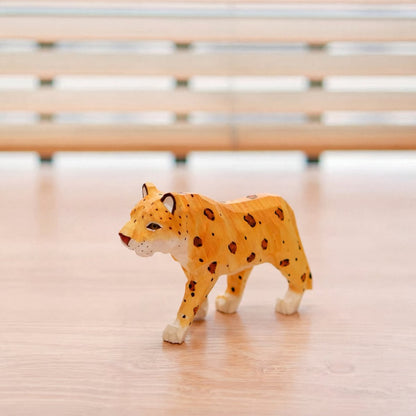 Front view of a hand-painted wooden leopard craft figure