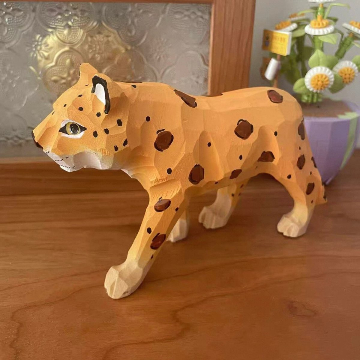 Close-up of painted details on a DIY wooden leopard figure