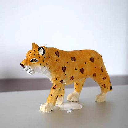 Side view of a hand-painted wooden leopard animal figure