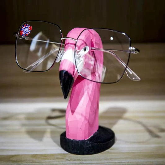 Hand-carved wooden flamingo eyeglass holder displayed as a charming desk accessory.