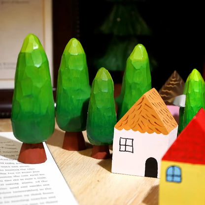 Painted wooden forest village displayed across an open English book