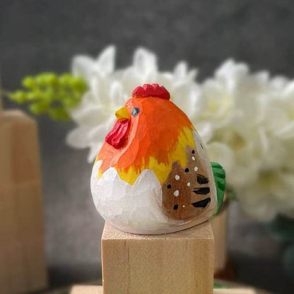 Close-up of a hand-painted wooden rooster figurine with colorful details