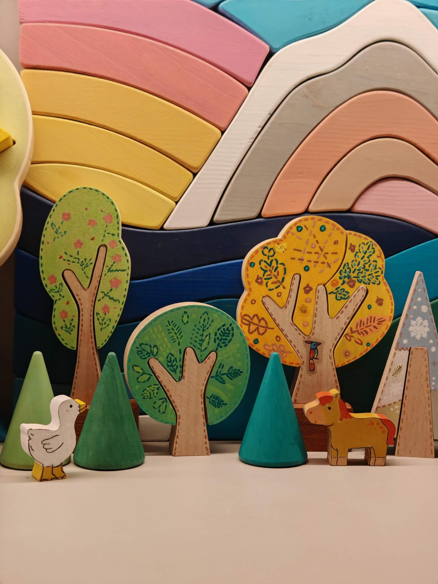 Colorful painted wooden tree forest displayed with small animals