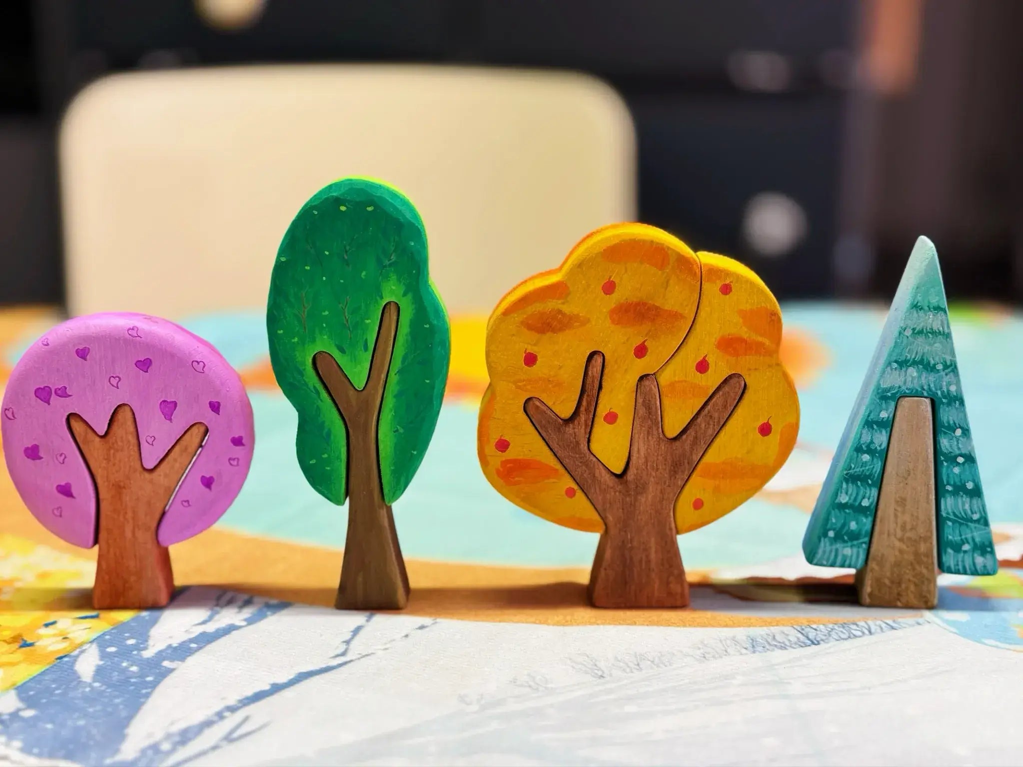 Four painted wooden tree shapes displayed together