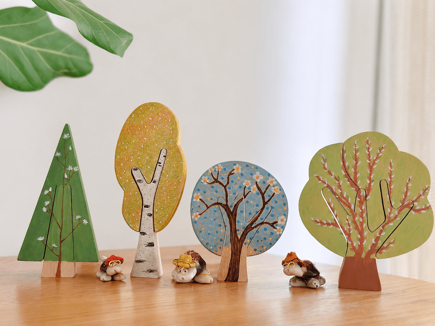 Painted wooden trees arranged in a small nature scene