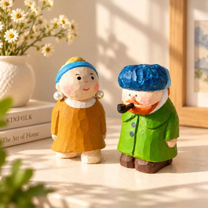 Pearl Girl and Van Gogh wooden figurines standing side by side in a softly sunlit room