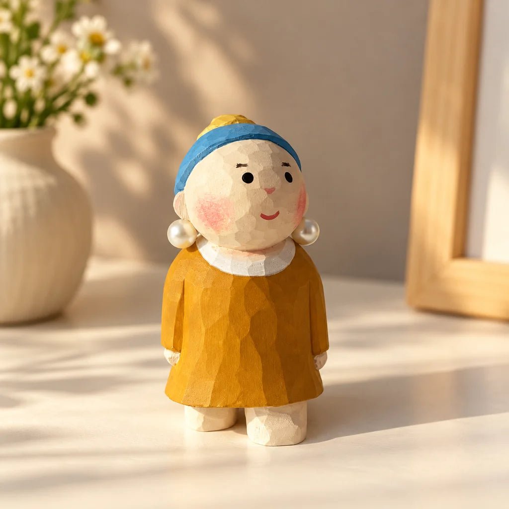 Hand-carved Pearl Girl wooden figurine wearing a blue headband, pearl earrings, and a yellow dress