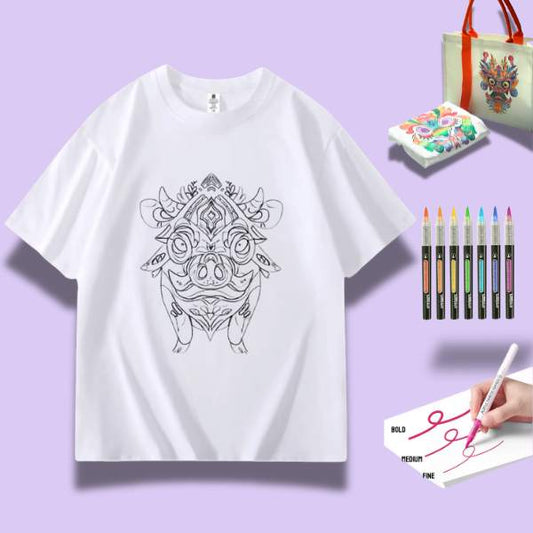 A white t-shirt featuring a detailed doodle of a proud pig surrounded by art supplies including markers and watercolor paints.