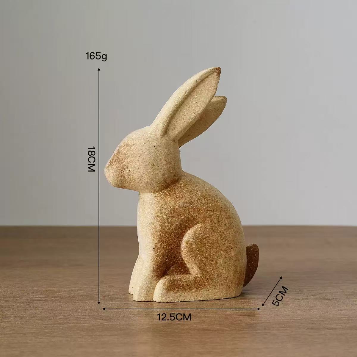 A decorative rabbit statue made of acrylic, with dimensions of 18cm height, 12.5cm width, and 5cm depth, weighing 165g.