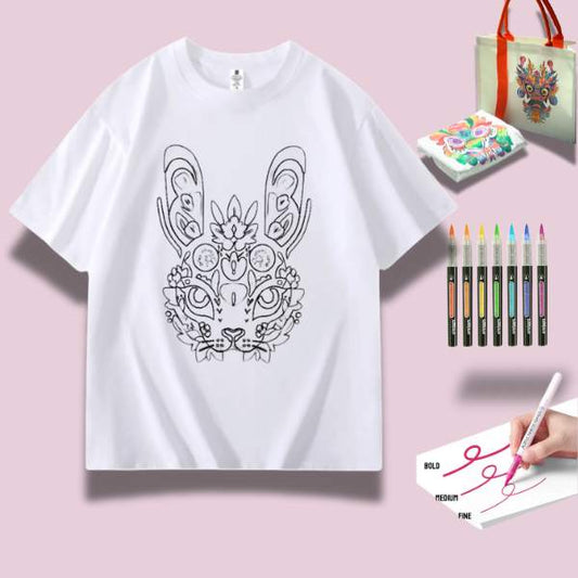 A DIY Doodle kit featuring a charming rabbit design on a white t-shirt, surrounded by vibrant coloring materials and accessories.