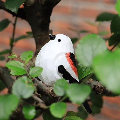 A charming wooden bird sculpture painted in bold red and black colors with a striking black beak, crafted and decorated using acrylic paint for a unique and artistic finish.