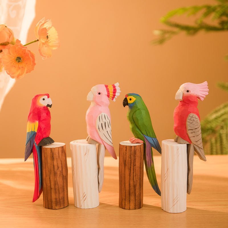 Colorful wooden decorative birds perched on logs