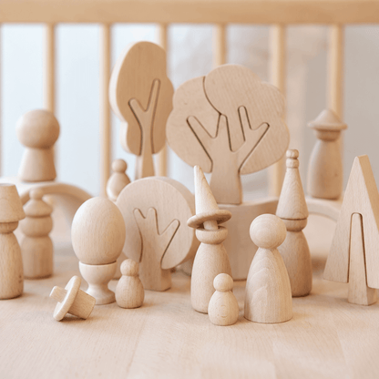 Four unfinished wooden tree shapes displayed together for DIY painting