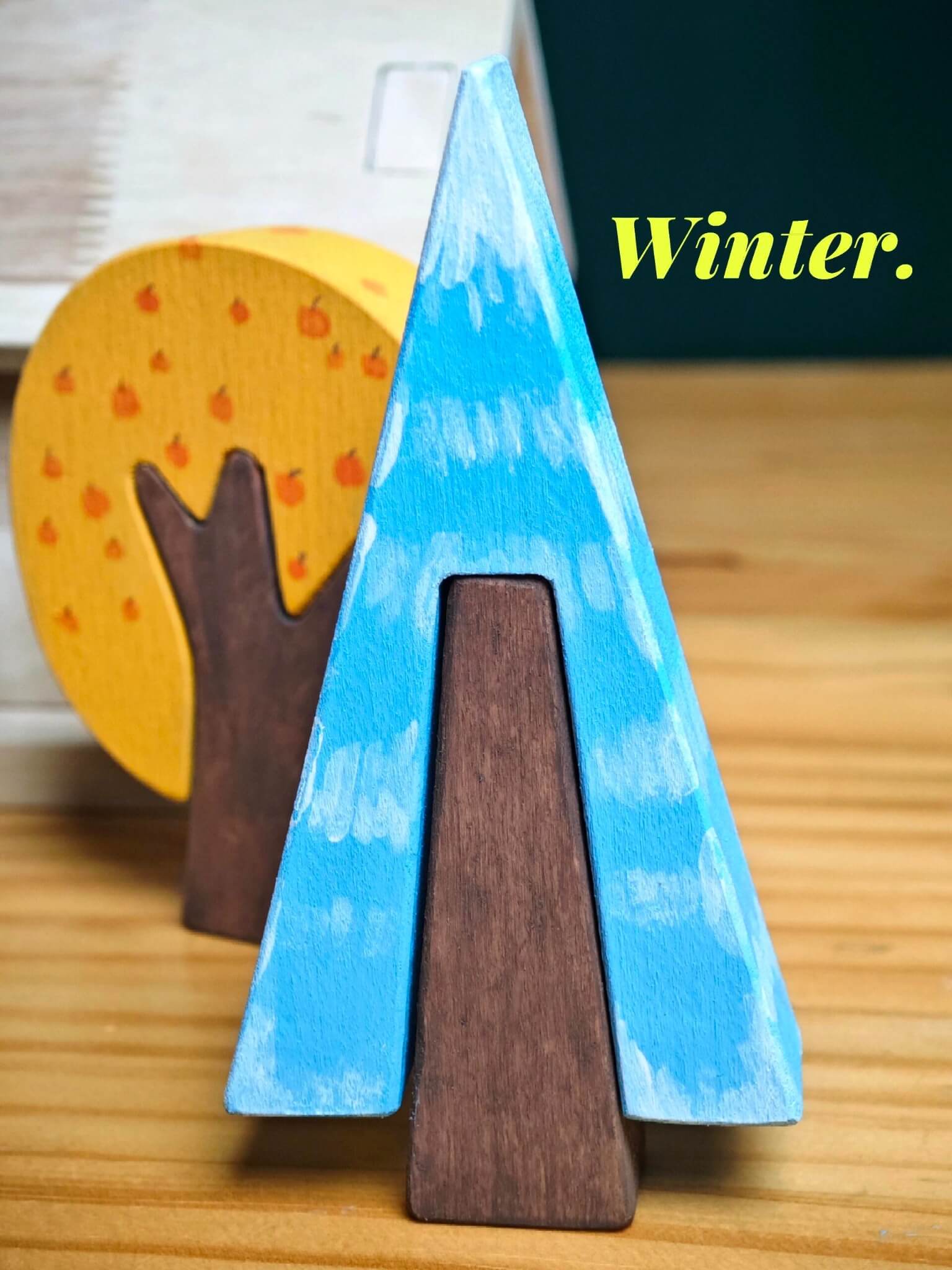 Blue hand-painted wooden pine tree inspired by winter