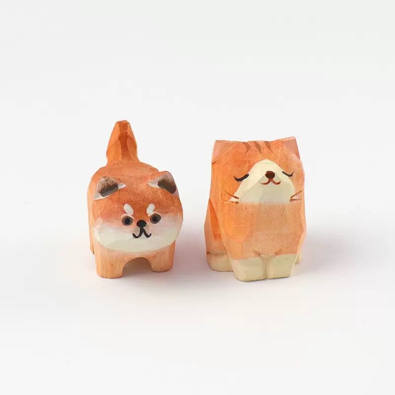 A pair of cute wooden cat and dog figurines featuring adorable expressions.