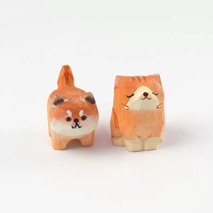 A pair of cute wooden cat and dog figurines featuring adorable expressions.